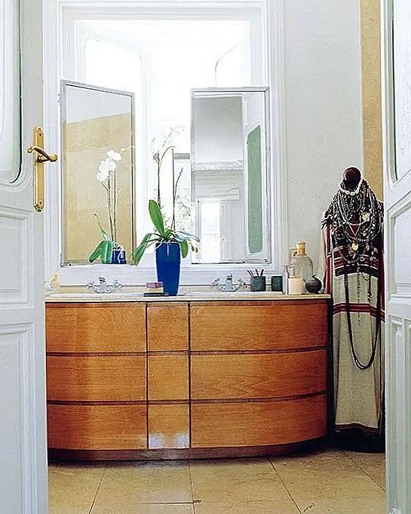 Многоцелевая комната полна света и белого цвета, и она отлично контрастирует с золотой подушкой и красными цветами в вазе. Все место дышит и показывает хороший вкус и глаз для дизайна интерьера. {Найден на micasarevista}