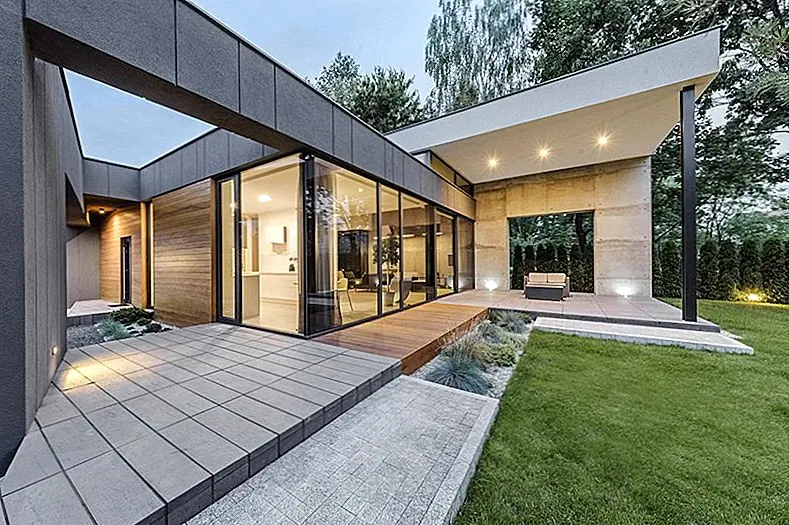 Небольшие размеры участка и близость к дороге вызвали ряд проблем и проблем для архитекторов. Клиенты хотели, чтобы дом чувствовал себя открытым и связанным с его окружением, но в то же время должен быть закрыт и защищен, чтобы не жертвовать неприкосновенностью частной жизни. Чтобы это произошло, архитекторы спроектировали закрытый блок на Юге с темным фасадом цвета и вторым пятном на север со светло-серым внешним видом. Основные отверстия были размещены в районах, где эти два блока пересекаются.