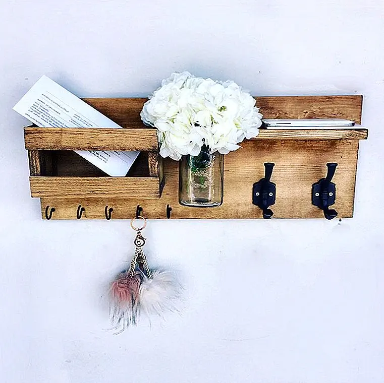 Много деревянных изделий ручной работы имеют деревенский вид, и это естественно. Нам нравится их чистое и необработанное очарование. Вы можете увидеть его здесь, в дизайне этого органайзера, доступного на Etsy. У него есть небольшая полка и отделение для почты, а между ними есть специальный слот для вазы с банкой. Маленькие крючки отлично подходят для подвешивания ключей, а два больших - идеально подходят для пальто. Их черная отделка добавляет приятный контраст.