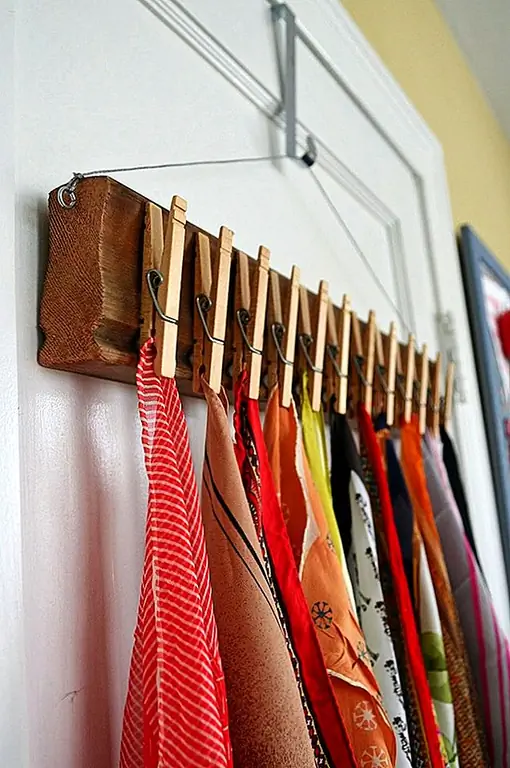 Шикарной идеей может быть создание органайзера шарфа из куска дерева и кучу деревянных прищепок. Вам просто нужно приклеить булавки к дереву, а потом повесьте свой новый органайзер. Вы также можете установить его на стене в подъезде.