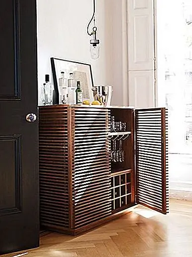 Линейный бар был спроектирован по запросу после того, как медиа-консоль поразила всех своей красотой. Затем дизайнер придумал эту пьесу с тем же источником вдохновения, что и консоль: упрощенные формы стереокомпонентов 1960-х годов. Бар имеет прочную американскую рамку из орехового ореха, а также сделан из MDF и орехового шпона. Это стоит $ 3,295.00. В баре есть два ящика с кожаными притяжениями вместе с тремя открытыми кубиками и шкафом для хранения, который вмещает до 12 бутылок. Эта часть является съемной. Там также висячие стеллажи для хранения стекол. В целом, это очень элегантная мебель, и она выглядела бы прекрасно в современной столовой или гостиной.