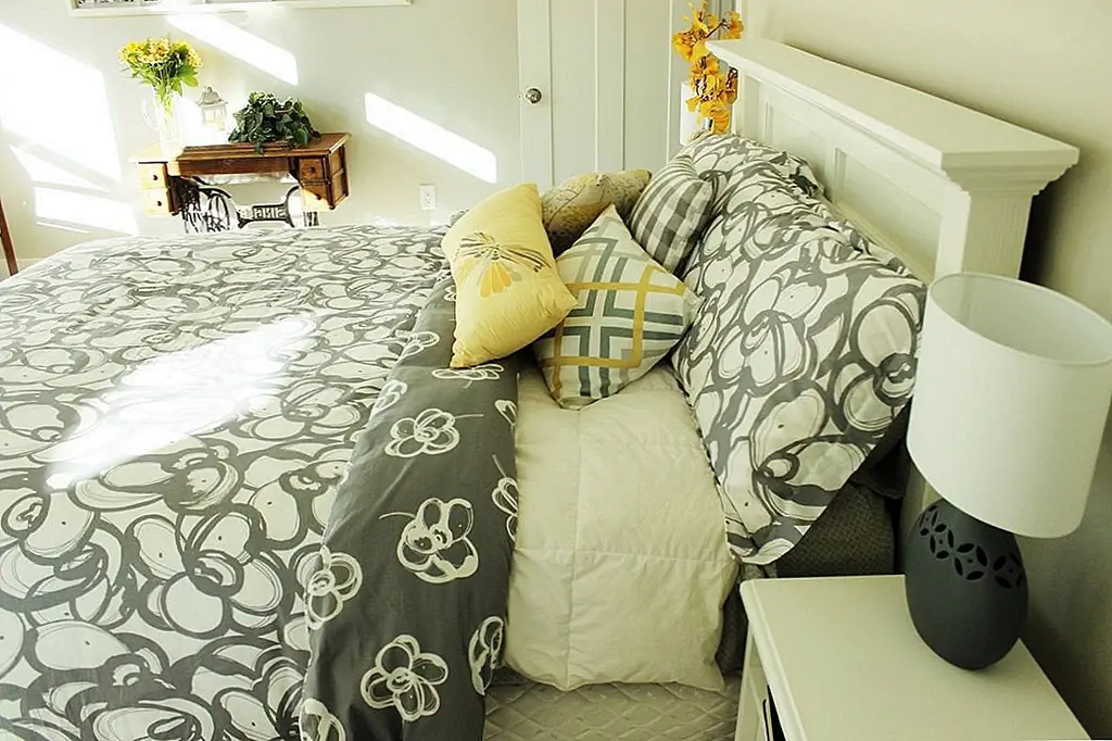 Основа такая же, как и любая базовая кровать, что в первую очередь с установленными и плоскими листами. Утешитель (белый) подтягивается под подушками, а пуховое одеяло (серое) подтягивается, а затем складывается для дополнительной глубины и контраста.