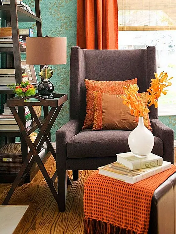 Этот уголок полон приветственных настроений и традиционной внешности. Но с добавлением сгоревших оранжевых занавесок, бросьте подушки и шарф, в комнату вошла новая жизнь и личность.