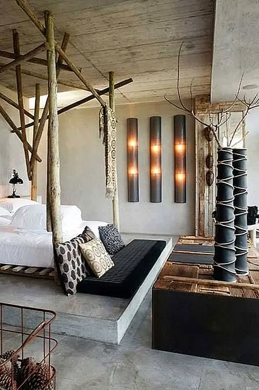 Использование природных материалов и текстур прекрасно подчеркивается здесь в виде уникальной кровати. Он сидит на том, что кажется бетонной платформой, и имеет деревянную раму с декоративными элементами из тех же материалов. Конструкция имеет супер случайное чутье.